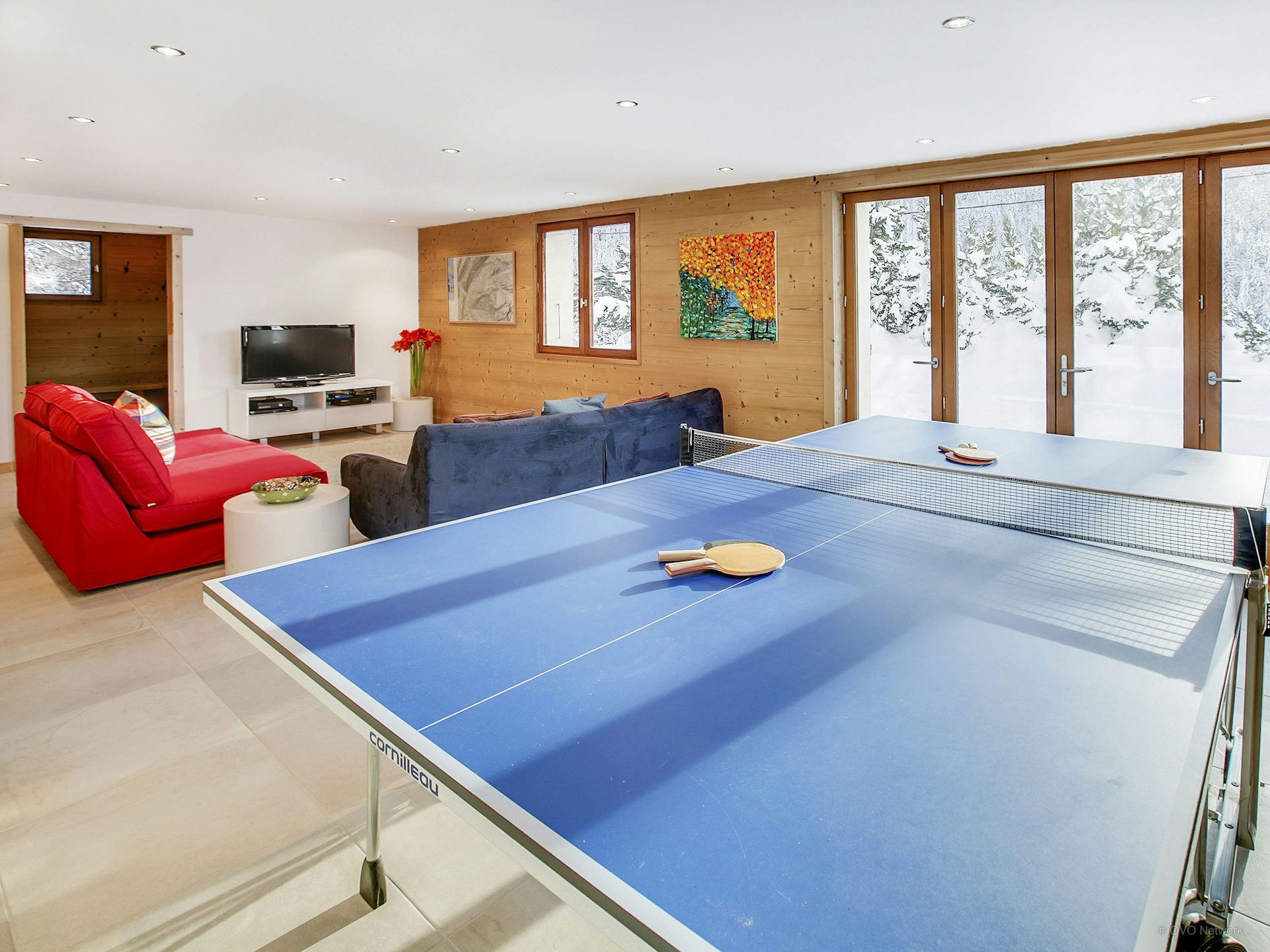 chalet-les-houlottes-room-with-ping-pong-table-and-sofas