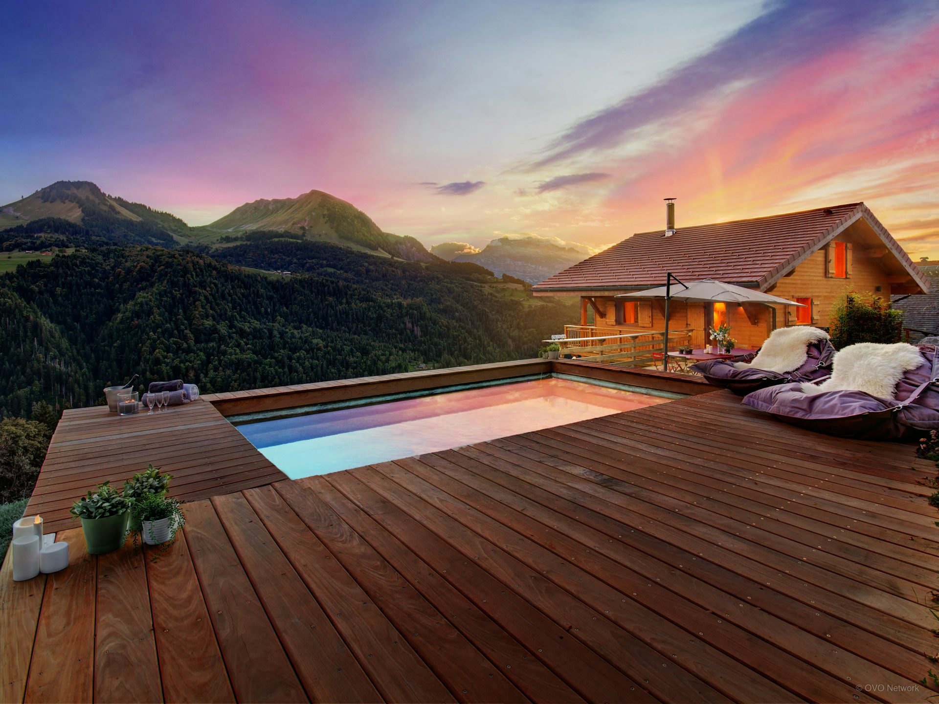 Swimming pool with mountain view at sunset