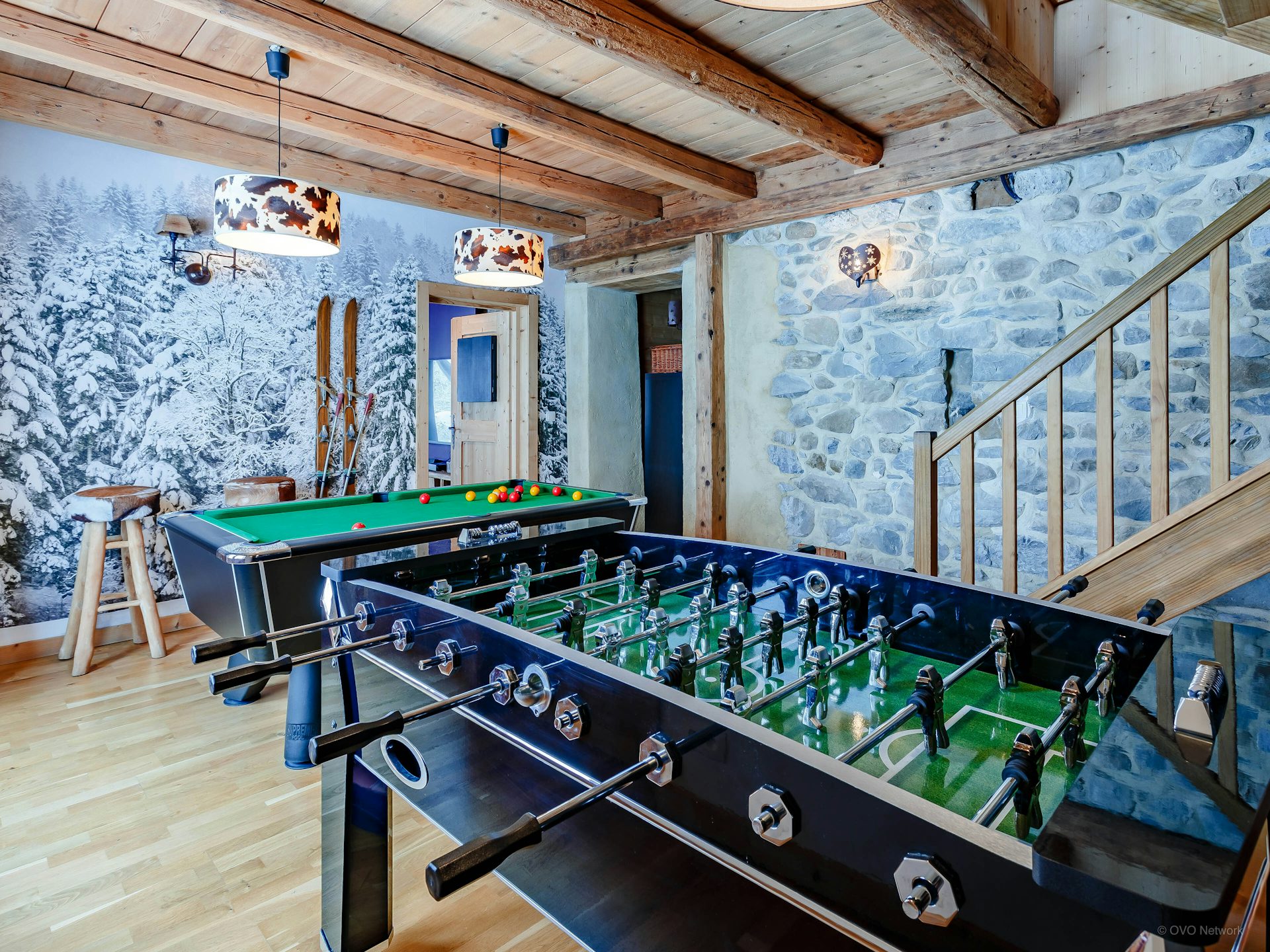chalet-keramis-game-room-stone-walls-snowy-tree-wallpaper-skis-foosball-table-snooker-table