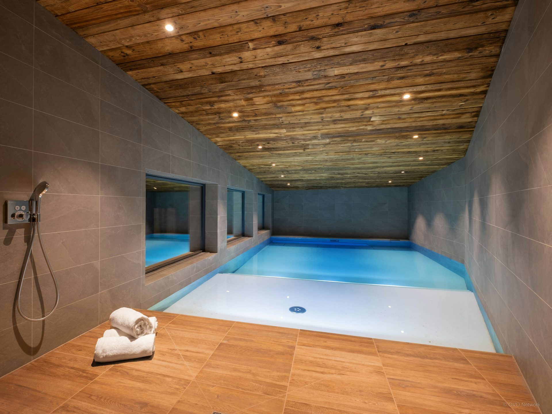 A stylish sloping swimming pool at Balmaz Lodge