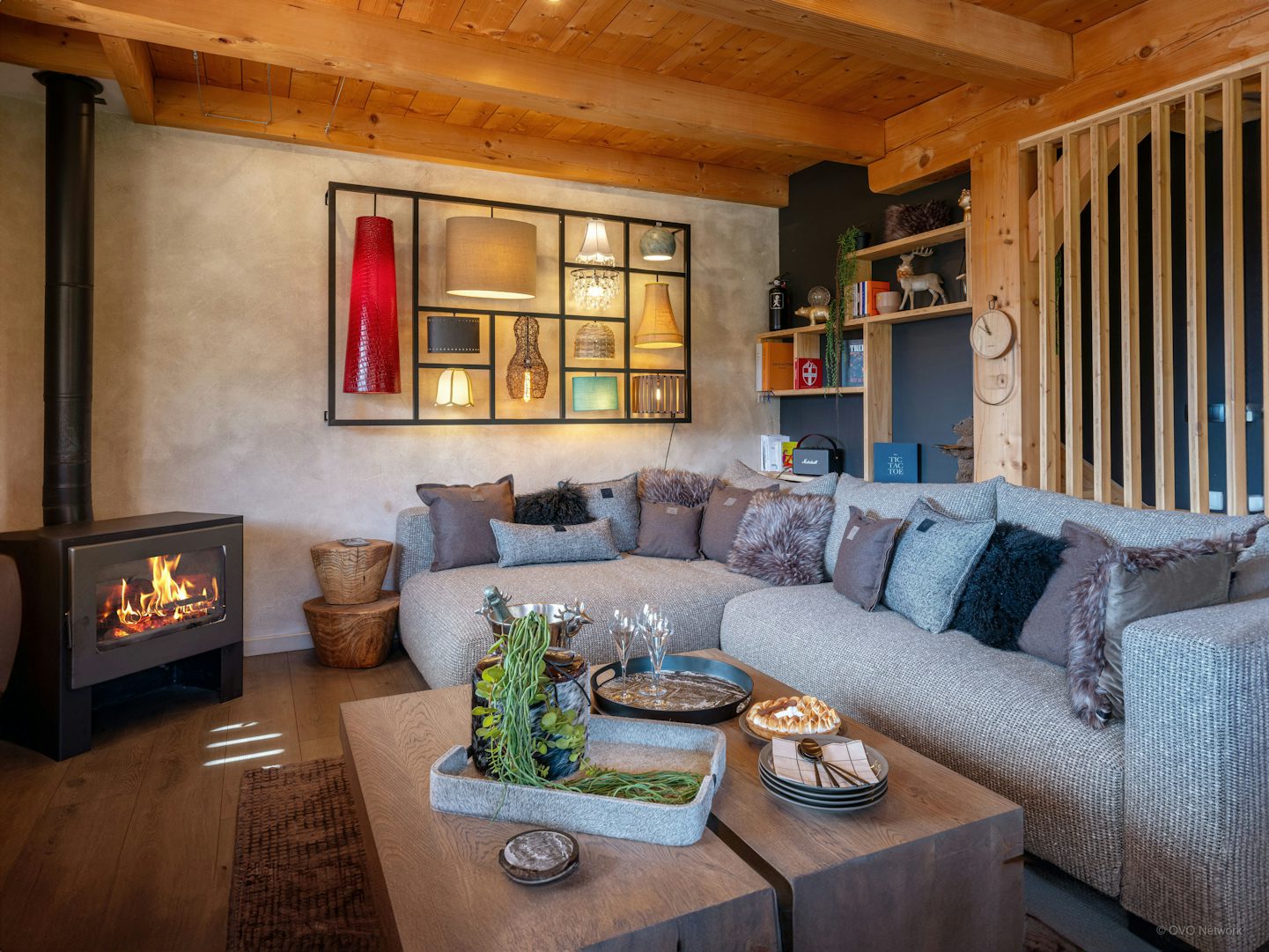 A cosy L-shaped sofa and woodburner at Chalaet Sivara